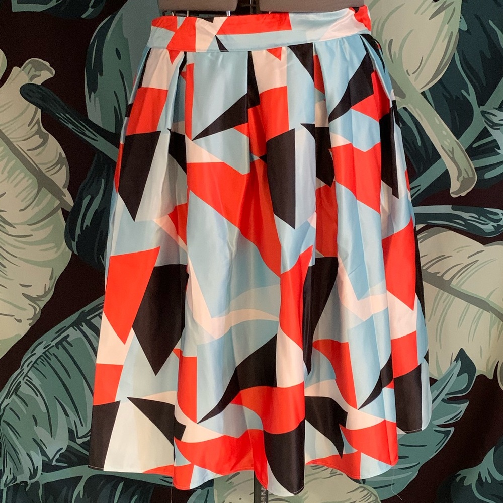Satin finish geometric pleated skirt